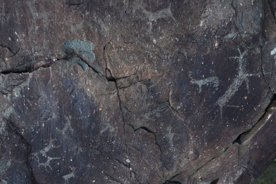 From above of dark gray natural slope with shabby surface and tiny aged paintings