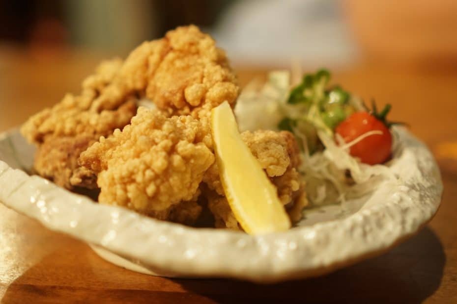 a plate of food on a table with a glass of beer